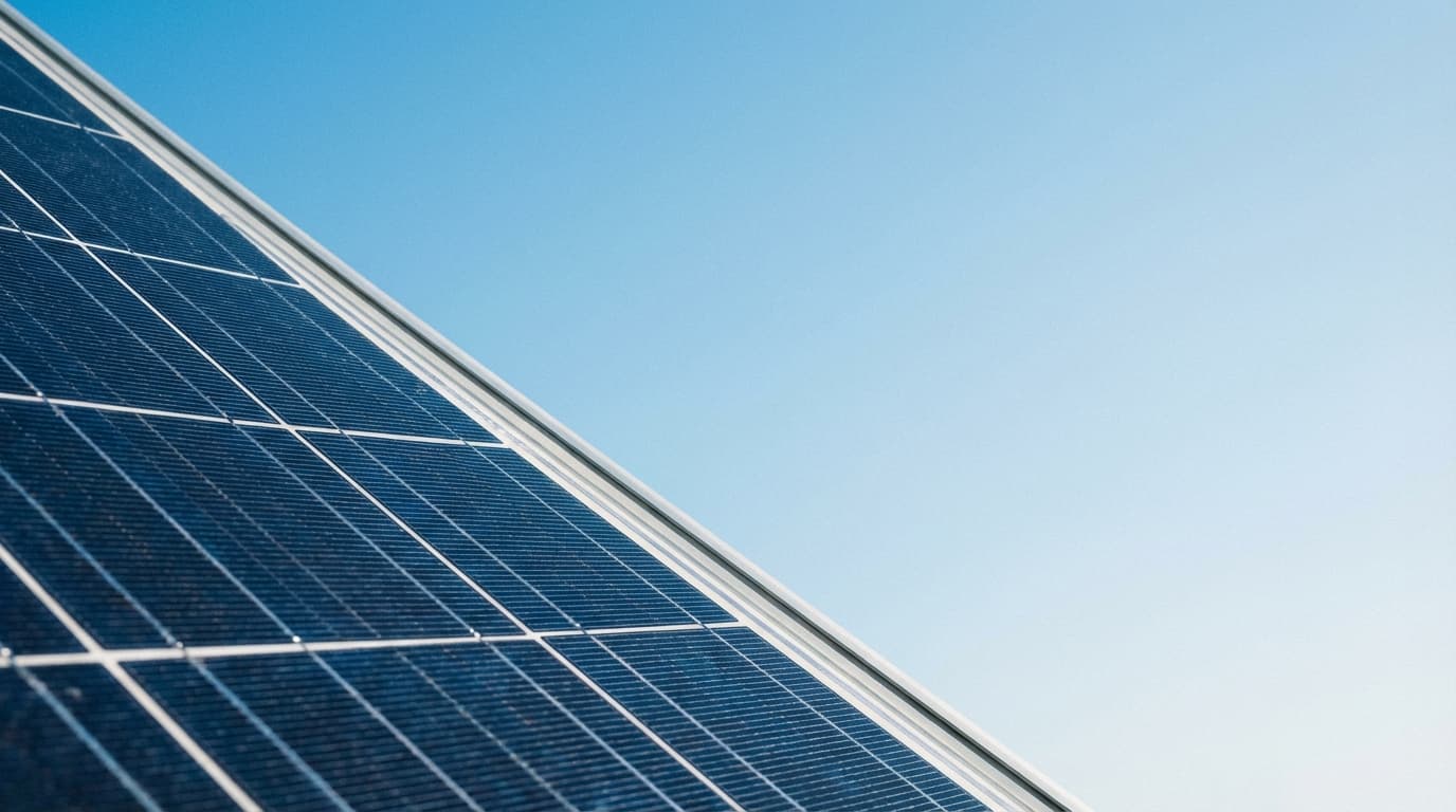 Solar panel closeup against a clear blue sky representing clean energy incentives